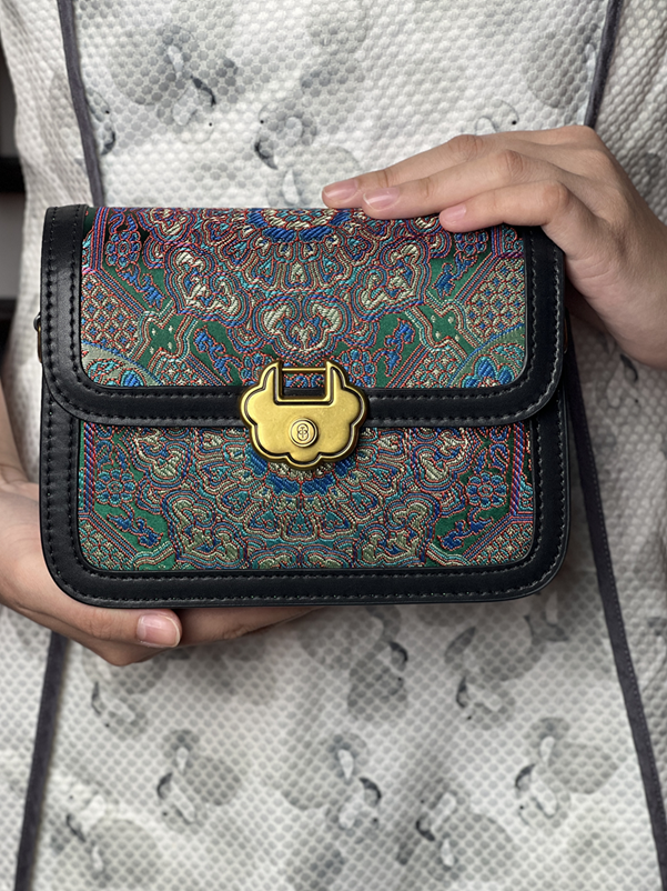 Goldene Signature‑Schließe der ARC Bag Dream Brokat – Premium‑Metallakzent auf kunstvollem Brokatstoff.